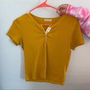 women's yellow short sleeve with silver buttons.
